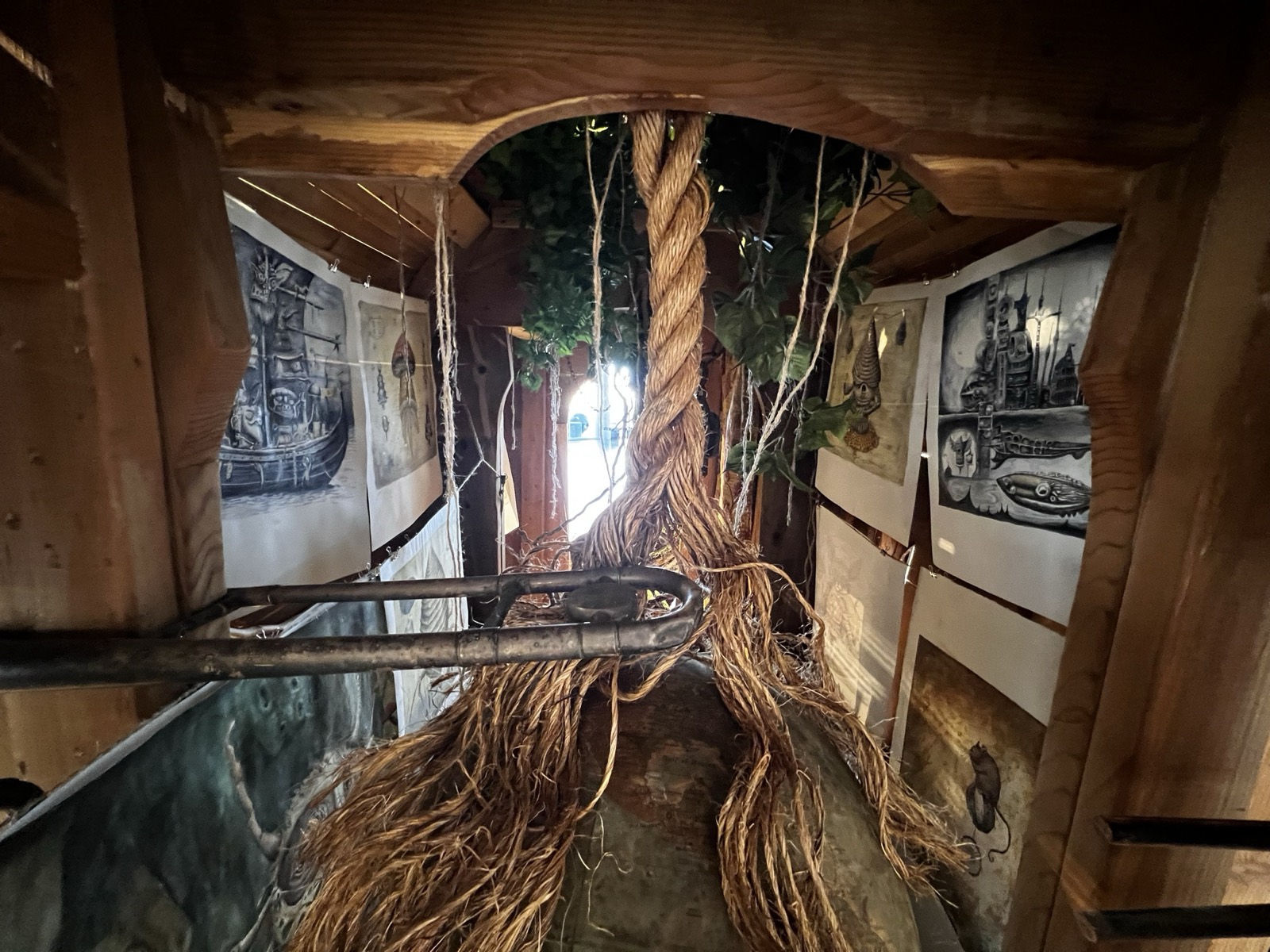 The Cabinet of the Wilding Hours: interior of the wagon, hung with roots and specimens.